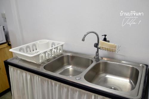 a kitchen sink with a dish drying rack next to it at V1-Baan Borijinda-Wooden House in The old city of Chiang Mai in Chiang Mai