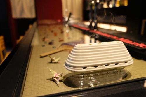 a stack of white plates sitting on a bowling lane at 万雷ホテル in Tokyo