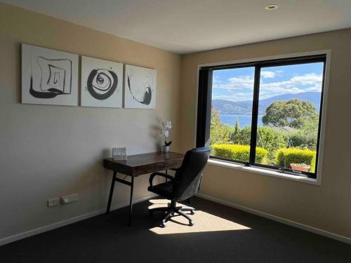 a office with a desk and a chair and a window at kunanyi horizons - Hobart in Tranmere
