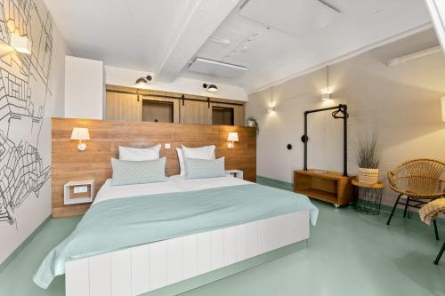 a bedroom with a large bed with a wooden headboard at Beachrooms Pier 7 in Vlissingen
