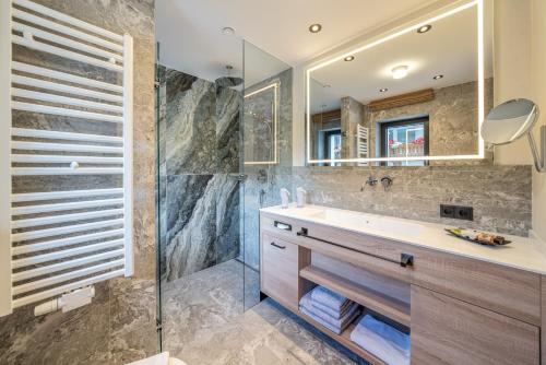 a bathroom with a sink and a shower at Hotel Wiesental in Obergurgl