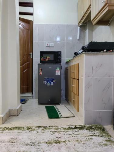 a kitchen with a small refrigerator in a room at Premier Stays Ruiru in Ruiru