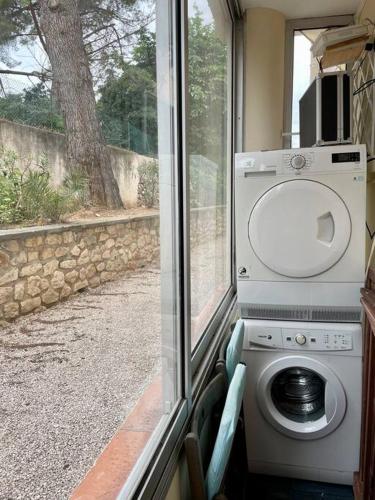 - un lave-linge dans une chambre avec fenêtre dans l'établissement Au coeur et au calme de Bandol, parking et climatisation, à Bandol
