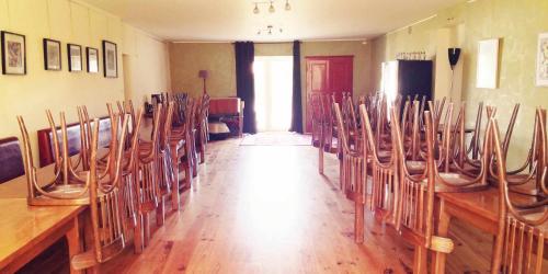 a row of chairs in a room with a table at Petit gîte ou chambre d'hôtes 2/4 personnes in Buffières