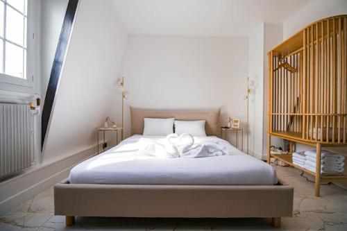 a bedroom with a bed with a bow on it at Typical Parisian Studio in Le Marais in Paris