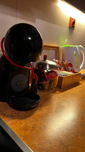 a kitchen counter with a coffee maker and pans on it at Apartmány Timea B 201 in Veľká Lomnica