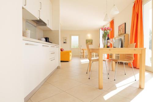 a kitchen and dining room with a table and chairs at CASA NAVLA' AppartamentI "Ulivi"- "Fiori" -"Velieri"-"Luna"-"Nido"-"Taverna" in Tignale