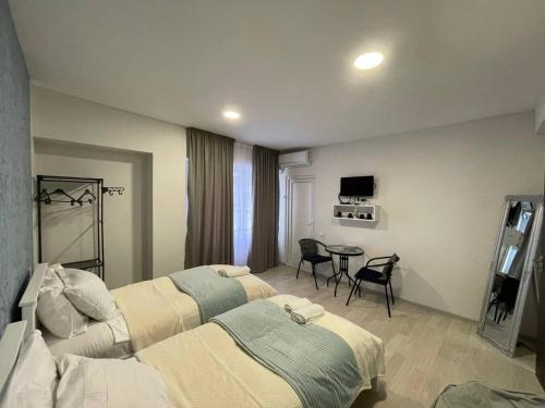 a hotel room with two beds and a table at Guest House in Old Tbilisi in Tbilisi City