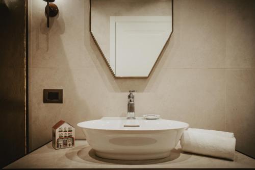 a bathroom with a white sink and a mirror at Hotel Giorgione in Venice