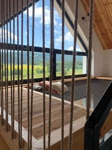 a room with a large window with a view at Lasosfera Lasówka in Lasowka