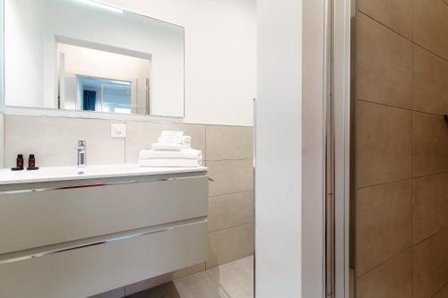 a bathroom with a sink and a mirror at Le Betulle Studios by Quokka 360 - studio apartments by the Origlio lake in Origlio