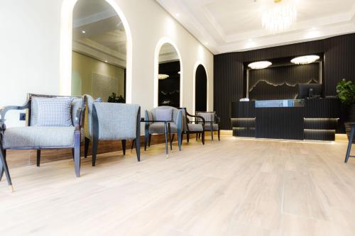 a salon with chairs and a table and a mirror at Ennesma Hotel in Casablanca