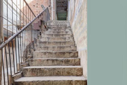 a set of stairs in an old building at OYO Hotel Shree Radha Guest House in Jhānsi