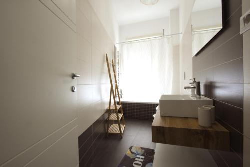 a bathroom with a sink and a window at Piramide Holiday House in Rome