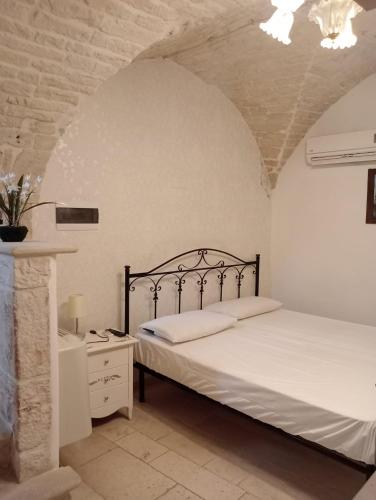 a bedroom with a bed and a dresser in a room at trullo Le murge in Alberobello