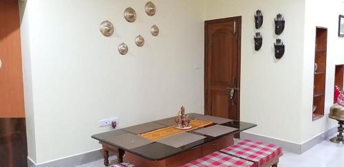 a dining room with a table and a bench at Drizzle Homestay in Guwahati