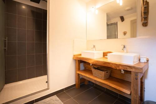 a bathroom with two sinks and a shower at grange rénovée en gîte/maison/chalet in Arreau