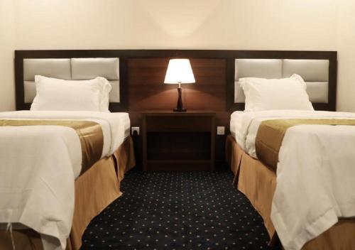 Säng eller sängar i ett rum på فندق فرسان البشائر