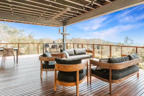 a deck with furniture and a view of the mountains at Montville Resort Style Holiday Retreat with pool in Perwillowen