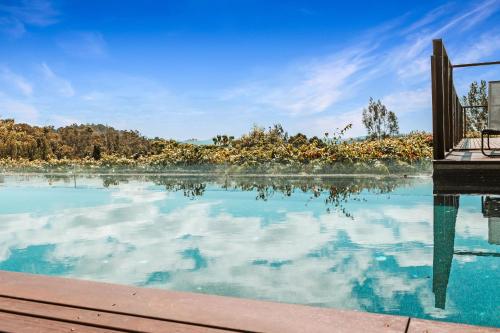 a pool of blue water with a wooden dock at Montville Resort Style Holiday Retreat with pool in Perwillowen