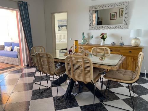 a dining room with a table and chairs at Cabana do Monte in Santa Bárbara de Nexe