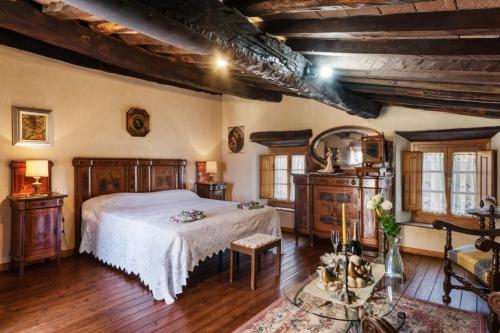 a bedroom with a bed and wooden floors and windows at Casa Teresina in Collodi