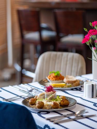 a table with two plates of food on it at Focus Hotel Szczecin in Szczecin