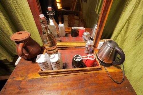 a wooden table with a tray with bottles on it at Nature Zone Jungle Resort in Munnar