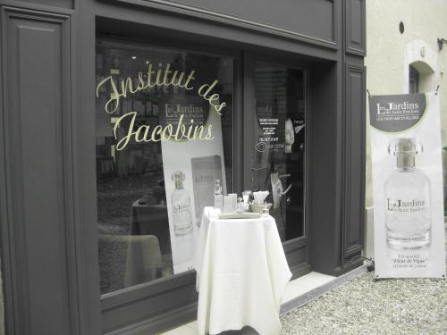 a store window with a table and a bottle of alcohol at L'appart des Jacobins in Saint-Émilion