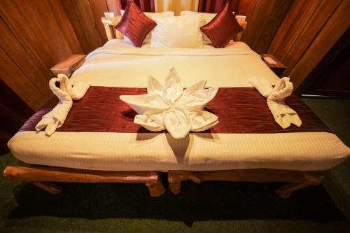a bedroom with two beds with towels on them at Nature Zone Jungle Resort in Munnar