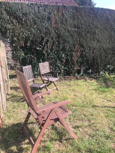 two chairs sitting in the grass in a yard at La Petite maison in Montleban