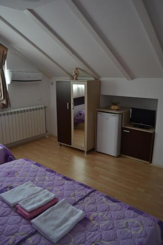 a bedroom with a bed with two towels on it at Villa Jankuloski in Ohrid