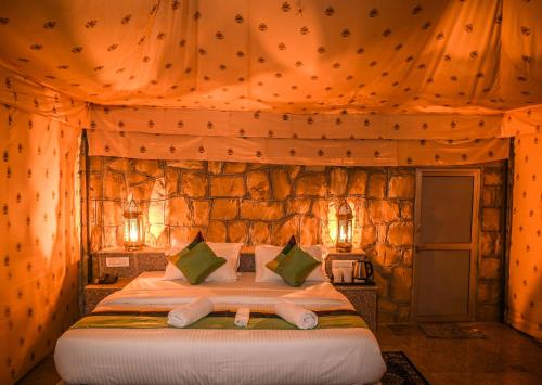 a bedroom with a bed in a tent at The Carvaans Resort in Jaisalmer