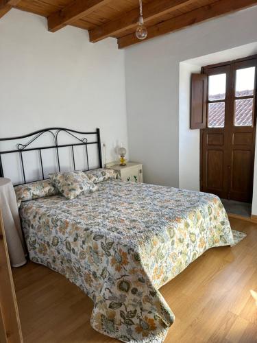 a bedroom with a bed and a wooden floor at Casa Fortuna in Armiello