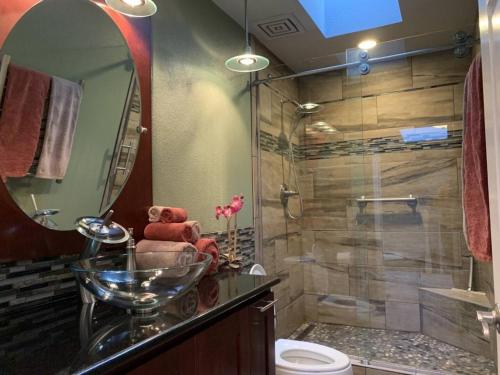 a bathroom with a shower and a teddy bear in a sink at Forest & City Views - Near Portland, Nike & Intel in Beaverton