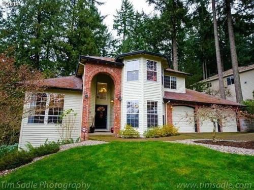 a white and red house with a yard at Forest & City Views - Near Portland, Nike & Intel in Beaverton
