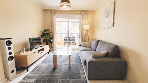 a living room with a couch and a tv at Apartment Fontana Golf Villamartin in Orihuela Costa