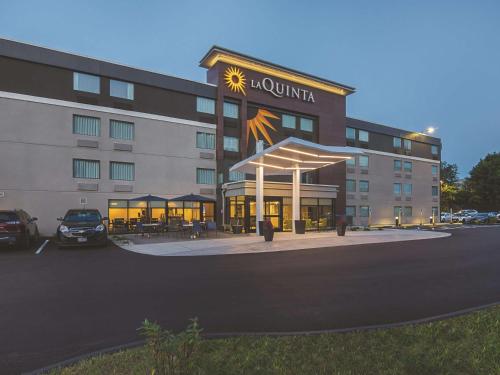 a hotel building with a courtyard with a restaurant at La Quinta by Wyndham Portland in Portland