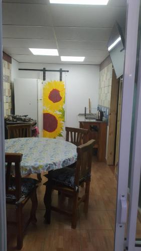 a kitchen with a table and chairs and a refrigerator at Cabañas en Koslay Ñalala Ivoqué con piscina climatizada en épocas cálidas in Juana Koslay 