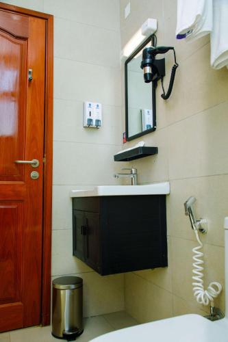 a bathroom with a sink and a mirror at Best Western Dodoma City Hotel in Dodoma