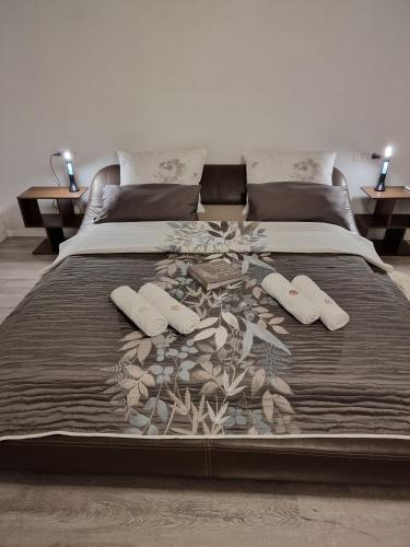 a large bed with two pillows and a blanket at Holiday House Nirvana in Bakarac
