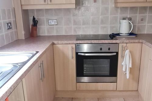 a kitchen with a stove top oven in a kitchen at Immaculate 3-Bed House in Durham near Sedgefield in Trimdon Grange