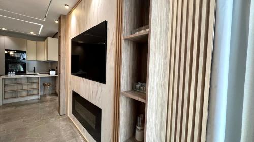 a living room with a tv on a wall at The Address - Sunny Anfa Hills in Casablanca