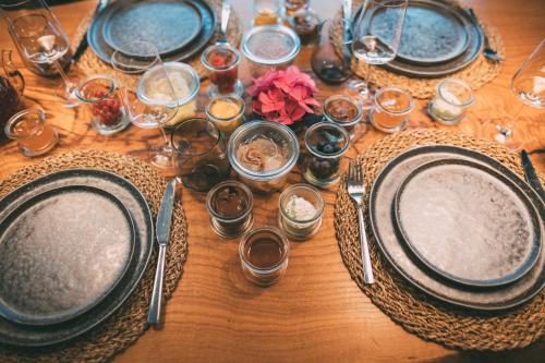 a wooden table with plates and utensils on it at Private Spa & Garden Alpi in Garmisch-Partenkirchen