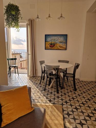 a dining room with a table and chairs and a window at Casa Vacanze Penelope in Pizzo