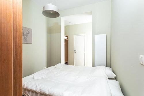1 dormitorio con cama blanca y espejo en Van Lerius studio, en Amberes