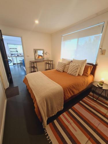 a bedroom with a large bed and a large window at 1 bedroom self-contained apartment in Lalor in Lalor