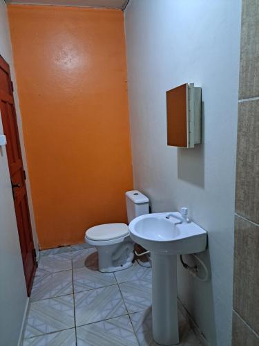 a bathroom with a toilet and a sink at AP 2 - Apartamento Mobiliado Tamanho Família - Cozinha Completa in Macapá