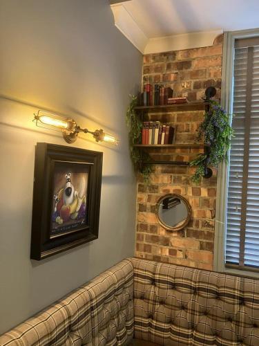 a living room with a couch and a brick wall at The Ivy Tree in Stockton-on-Tees