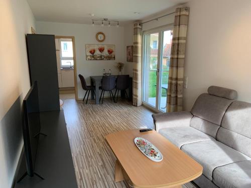 a living room with a couch and a table at BestBoarding24 in Schöllkrippen